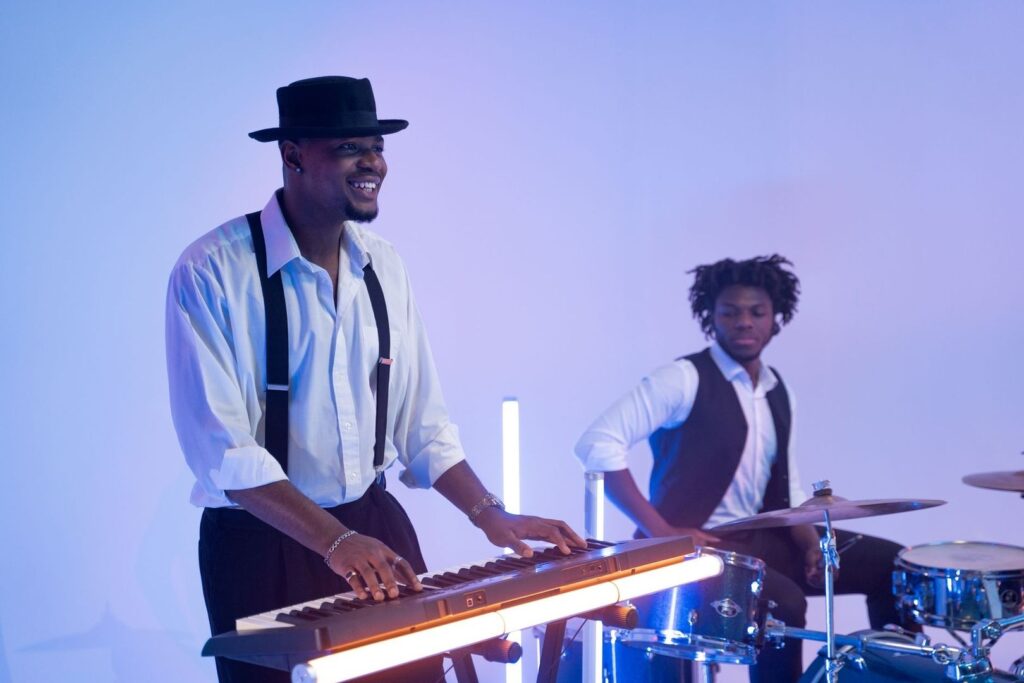 Musicians perform under blue and violet LED stage lighting
