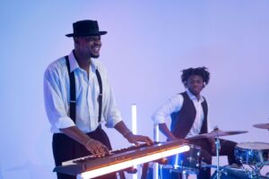 Musicians perform under blue and violet LED stage lighting